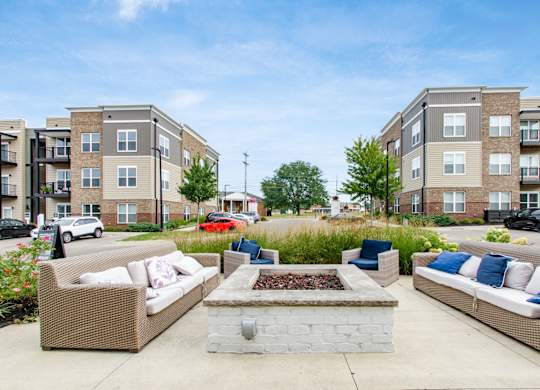 A sunny day at a residential area with apartment buildings and outdoor furniture.