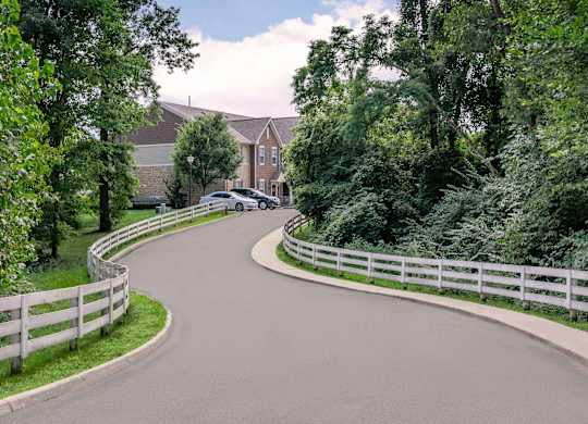 A car is parked on the side of a curvy road.
