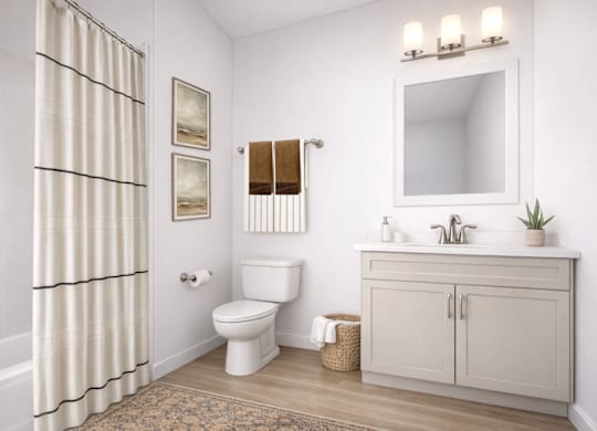 A white bathroom with a toilet, sink, and shower curtain.
