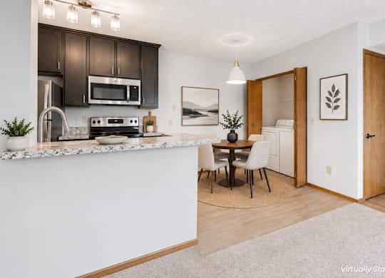 A kitchen with a white counter and brown cabinets.