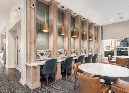 A dining room with a long table surrounded by chairs.