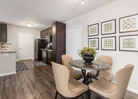 A dining room with a table and chairs.