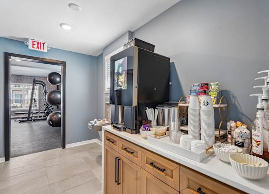 A kitchen with a black microwave above the counter.