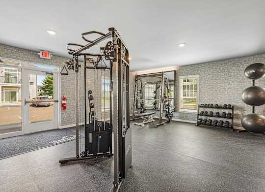 A gym with a weight rack and a mirror.