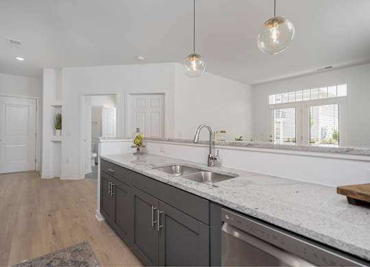 A kitchen with a sink and a window.
