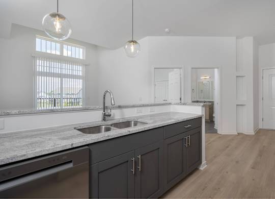 A modern kitchen with a sink and cabinets.