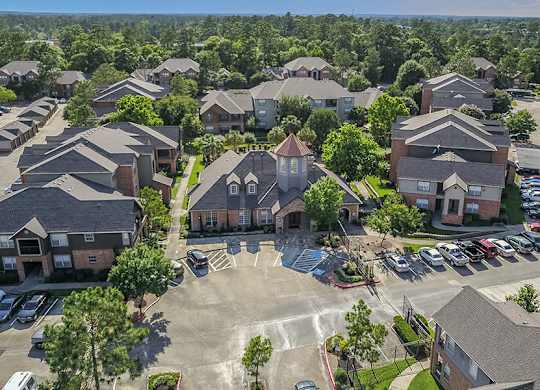 A bird's eye view of a residential area with houses and cars.