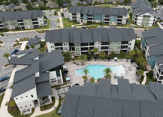 A bird's eye view of a residential complex with a swimming pool.