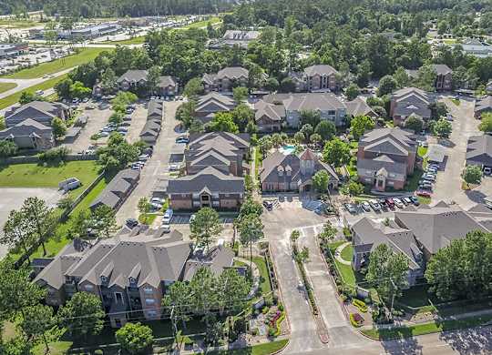 A bird's eye view of a residential neighborhood with houses and trees.