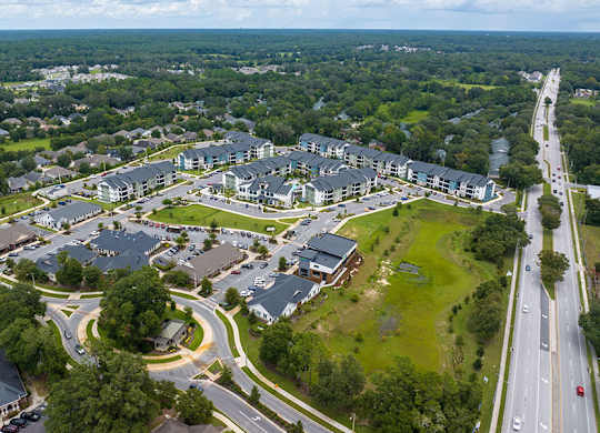 A bird's eye view of a residential complex with a roundabout in the center.