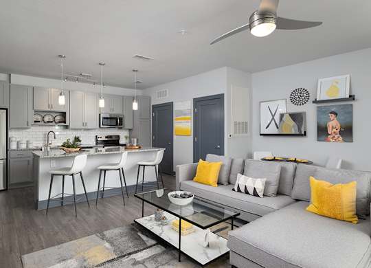A modern kitchen with a dining area and a living room.