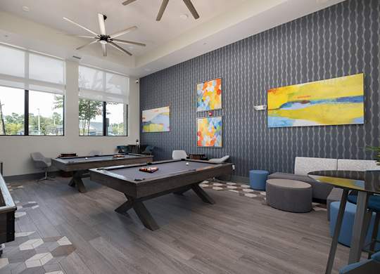 A room with a pool table and a billiard table.
