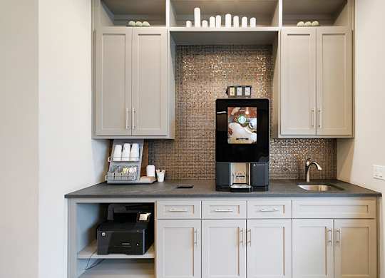 A kitchen with a microwave, oven, and sink.