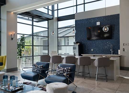 A modern living room with a yellow chair and a blue chair.