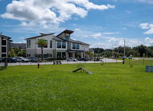 A grassy field with a building in the background.