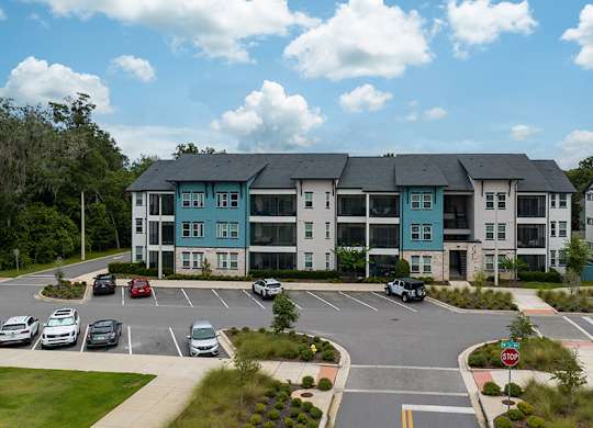 A large building with a parking lot in front of it.