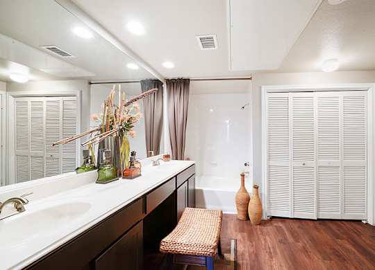 A bathroom with a white sink and a white toilet.
