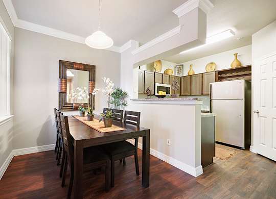 A kitchen with a table and chairs in the middle of the room.