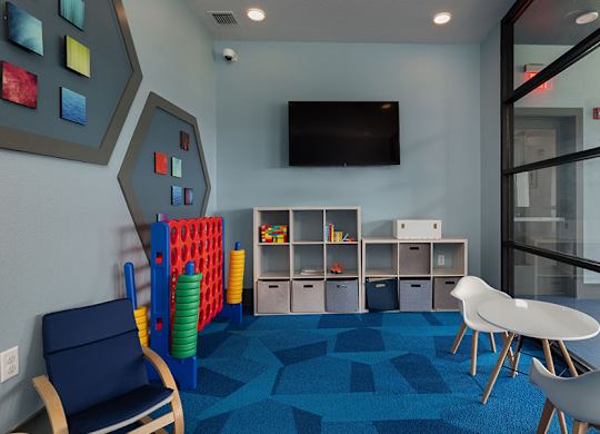 A room with a blue carpet and a white table.