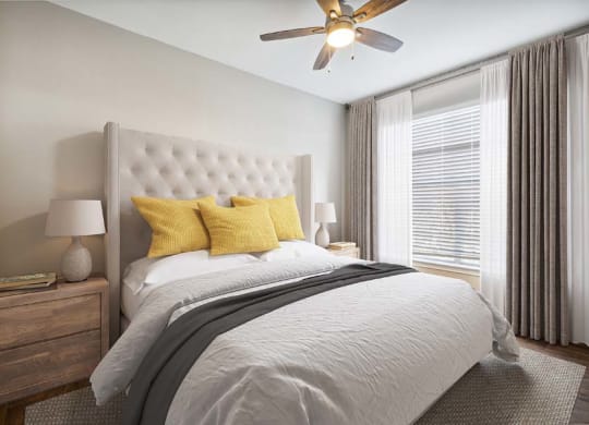 a bedroom with a bed and a ceiling fan