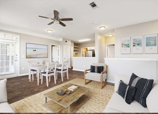 a living room filled with furniture and a ceiling fan