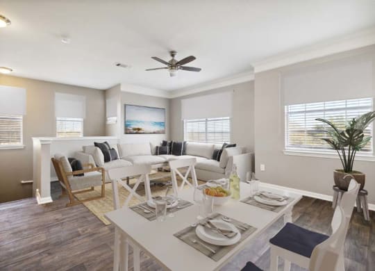 a living room filled with furniture and a ceiling fan
