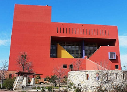 A red building with a yellow triangle on the front.