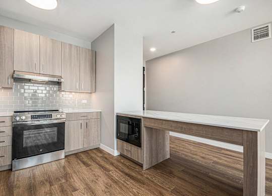 Fully equipped modern kitchen with wooden cabinets at Thrive Exchange, Chicago, IL, 60617