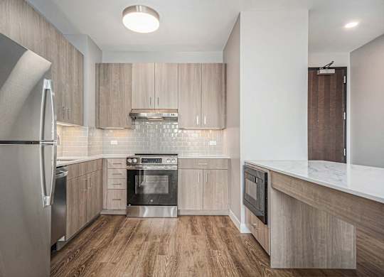 Stainless steel appliance in Modern kitchen with wooden cabinets at Thrive Exchange, Chicago, IL