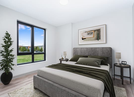a bedroom with a bed and a large window