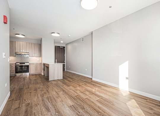 Spacious room with wooden flooring and a kitchen area at Thrive Exchange, Illinois , 60617