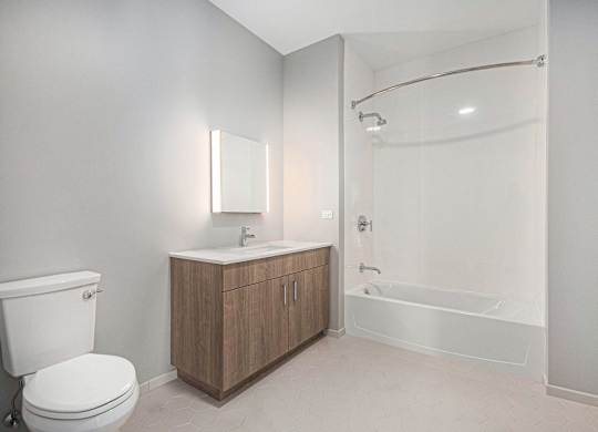 Bathroom with a toilet, sink, and shower at Thrive Exchange, Chicago, 60617