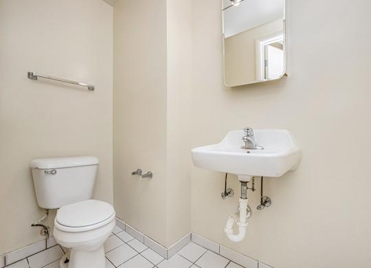 A white toilet and sink in a bathroom.