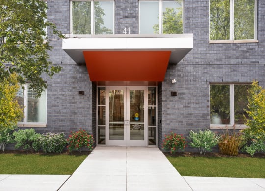 the entrance to a building with a red awning over the door