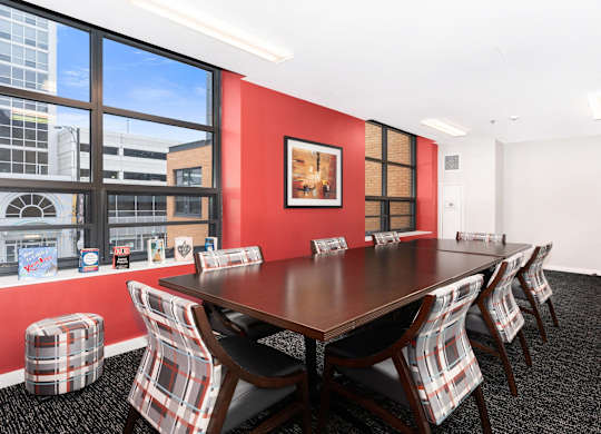 a conference room with a table and chairs and a large window