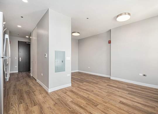 Spacious room with wooden flooring and white walls at Thrive Exchange, Chicago, IL, 60617