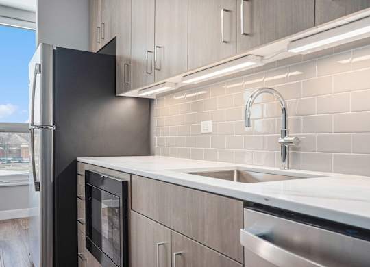 Kitchen with a refrigerator and cabinets at Thrive Exchange, Chicago, IL, 60617