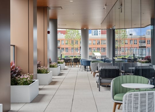 a large patio with tables and chairs and large glass walls  at Cassidy on Canal, Chicago, Illinois