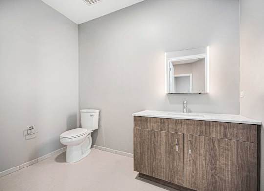 Toilet sits next to a sink in a bathroom at Thrive Exchange, Chicago, IL, Illinois