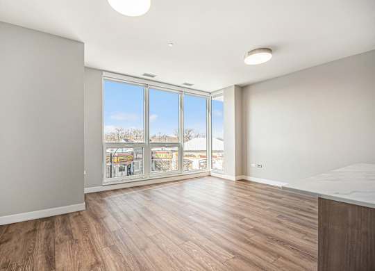 Living Room With Expansive Window at Thrive Exchange, Chicago, Illinois