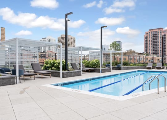 the pool on the rooftop of a building with a city in the background  at Cassidy on Canal, Chicago