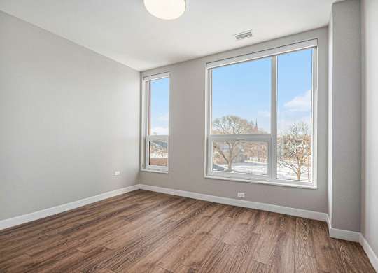 Room with a large window and wooden flooring at Thrive Exchange, Chicago, Illinois