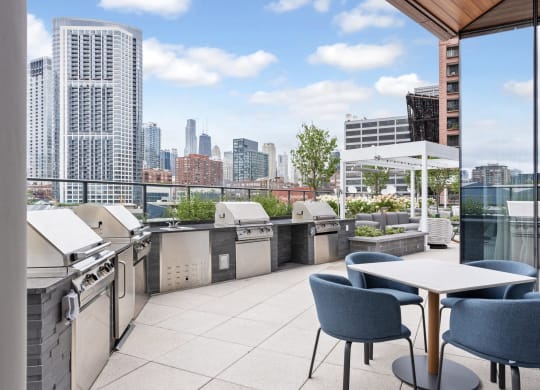 a rooftop patio with tables and chairs and a view of the city  at Cassidy on Canal, Illinois, 60606