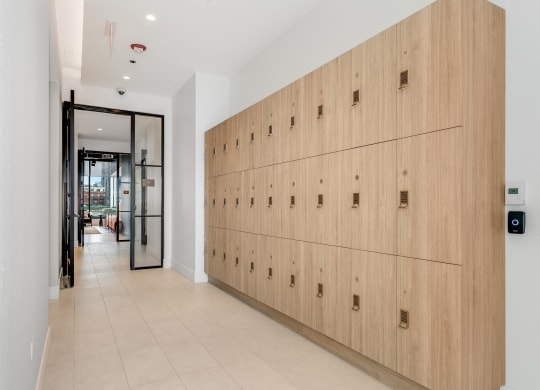 a long row of wooden lockers in a hallway of a building  at Cassidy on Canal, Chicago