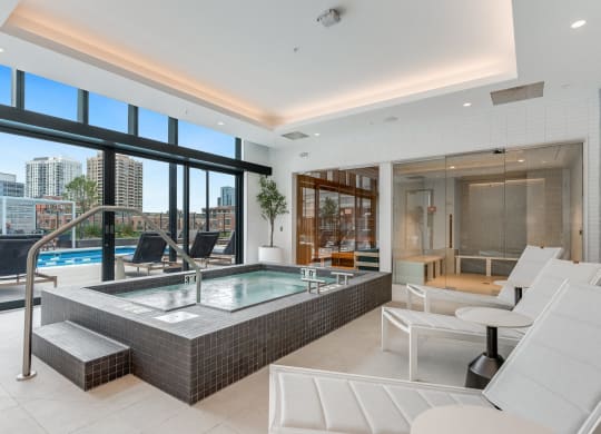 a spa area with a jacuzzi and a pool in a luxury apartment  at Cassidy on Canal, Chicago, 60606
