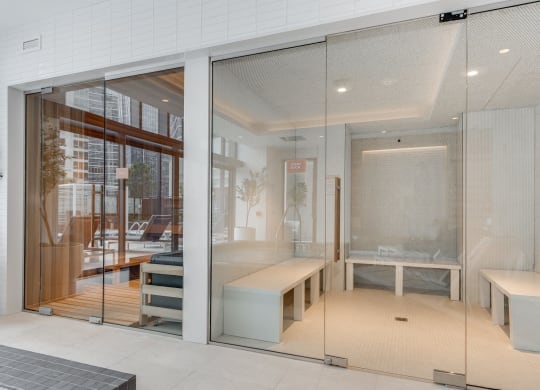 a glass walled room with a bed and a table at Cassidy on Canal, Chicago, IL