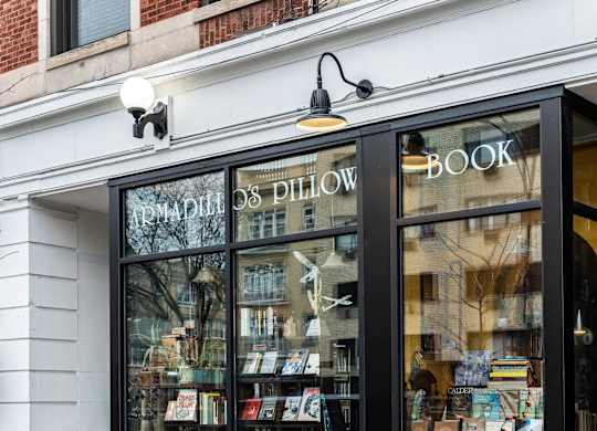 the front of a bookstore with books in the window