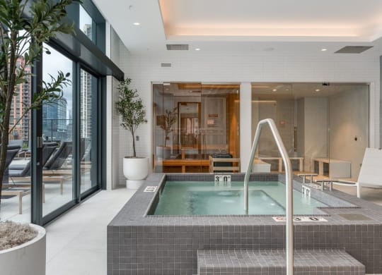 a large jacuzzi pool in the middle of a room with glass doors at Cassidy on Canal, Chicago