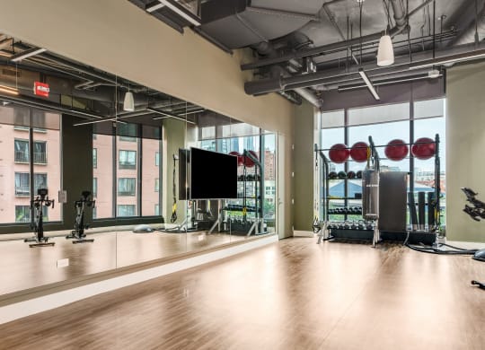 a workout room with a large window and gym equipment  at Cassidy on Canal, Chicago
