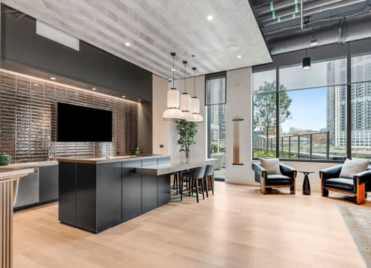 a kitchen and living room with a large window and a tv at Cassidy on Canal, Chicago, Illinois